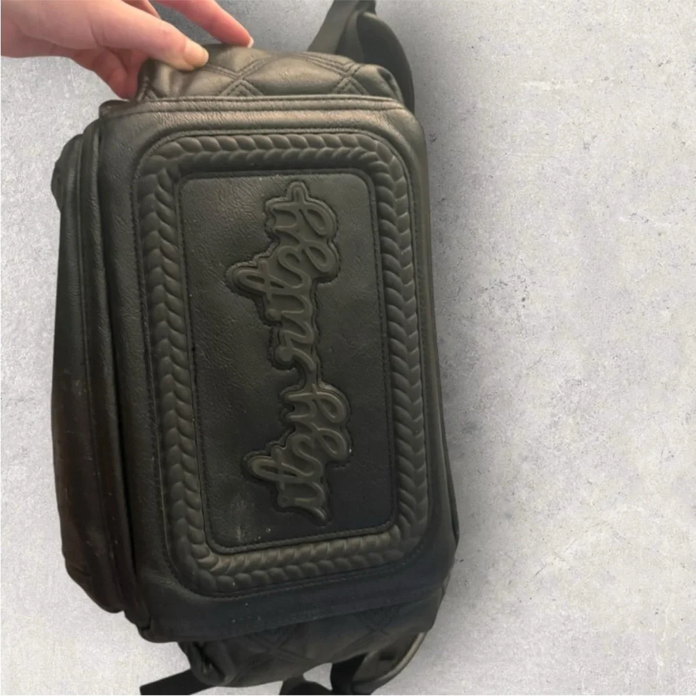 Itzy Ritzy Boss Plus black diaper bag backpack with gold hardware.